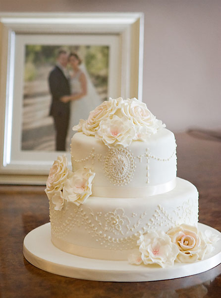 Delicate Piped Lace and Brushed Embroidery with Large Sugar Roses.