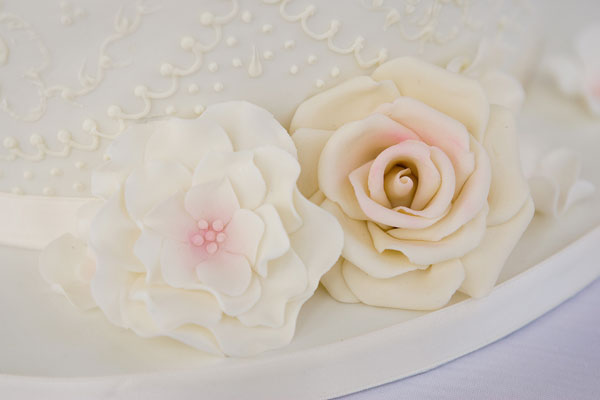 Delicate Piped Lace and Brushed Embroidery with Large Sugar Roses.