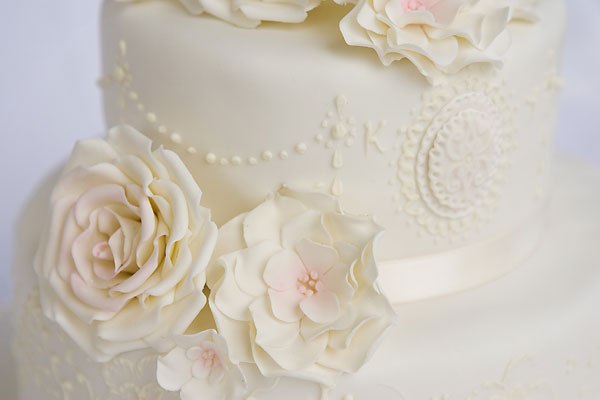 Delicate Piped Lace and Brushed Embroidery with Large Sugar Roses.
