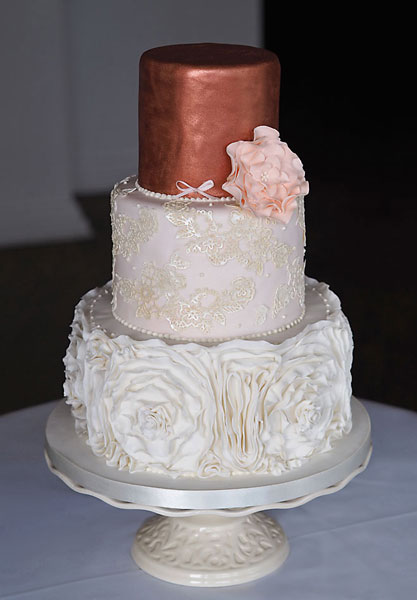 Rose Gold Ruffle Wedding Cake, Delicate Sugar Ruffles, Lace with Ivory Shimmer and Metallic Rose Gold Top. Finished with a Large Blush Sugar Open Rose. 