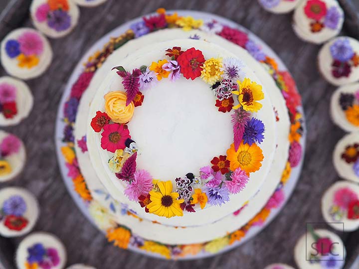 Vibrant Buttercream Wedding Cake with Fresh Edible Flowers, Floral Crown and Matching Cupcakes